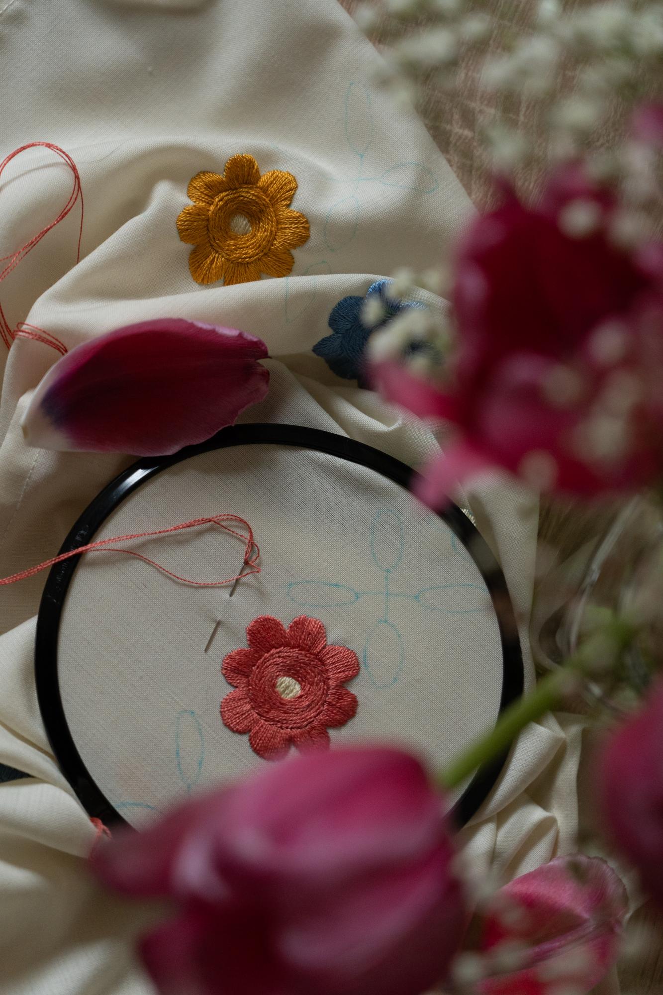 Small embroidered flower on natural linen
